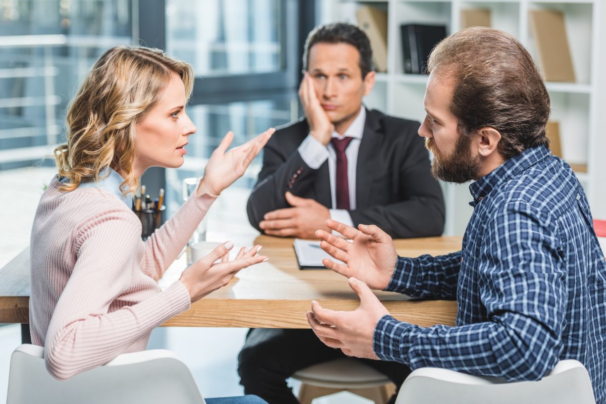 side-view-of-couple-arguing-at-workplace-in-lawyer-office.jpg